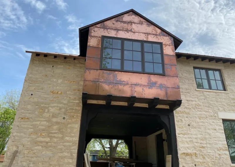 Copper metal panel facade on a stone building for Skylight Installation in Bear Valley Springs